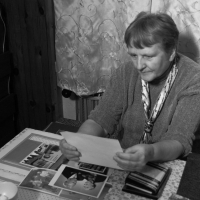 Christa Petrásková looking at period photographs