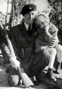 With her grandfather, who is in the uniform of the legionnaire from WWI