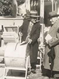 Father Josef Barton demonstrates a hand washing machine at the fair