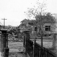 House in which Milada survived the air raid was destroyed. The cellar-shelter window is shown with a white arrow