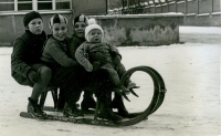 Three sisters and brother Jaroslav, held by Klára, on a sleigh in Mladá Boleslav, 1935