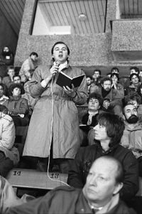 Public performance at the winter stadium in Hradec Králové (Jiří Sova on the right in front of the speaker), 6 December 1989