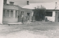 With his parents on the premises of the family company