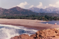 Lubomir and Veronika in Corsica in a blue tent with a red boat in the distance