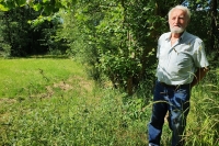 Václav Němeček at the overgrown pond above the mill in June 2024