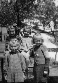 Emilie Kozubíková (bottom left) by the bakery in Bystřice, circa 1944