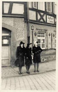 A photo of the witness (centre) with her friends from her stay in Germany - Jarka (left) and Hela (right), the two windows on the top right belonged to their rooms, 1944