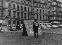 Vladimír "Chafer" Procházka Jr. in front of the sign "Better Šena in America than a Russian in the Republic", Gottwald Square, 23 August 1968