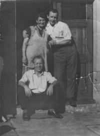 In the doorway of the house at Hálkova 23, Úvaly; mom, Miroslav, dad sitting, early 1950s