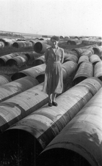 Wife Vítězslav Matušková standing on a pipe for the construction of a gas pipeline near Velka Polom in the Opava region