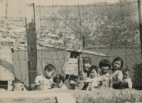 Korean children behind the fence of the DKNS base