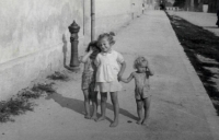 With younger sisters in the street