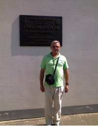 Václav Hušák infront of the memorial