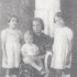 With his mother and sister as a child